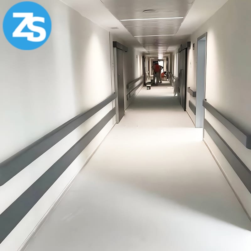 elderly care facility corridor with safety support handrail installed